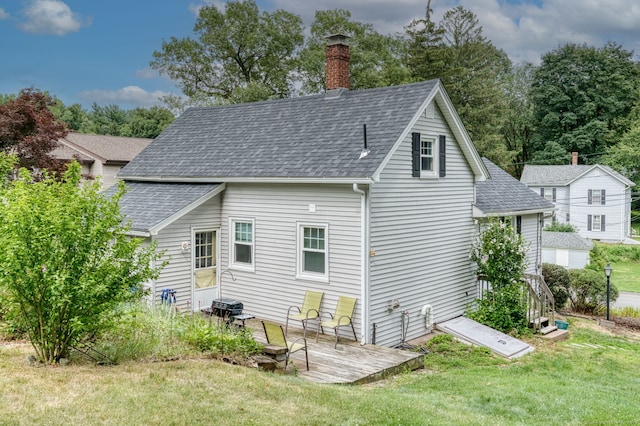 6 Rau Street Ext, Vernon, CT 06066 - rear view of property featuring roof with shingles, a lawn, a chimney, and a wooden deck