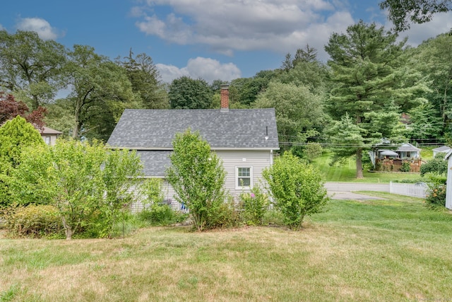 6 Rau Street Ext, Vernon, CT 06066 - view of side of home with roof with shingles, a yard, and a chimney