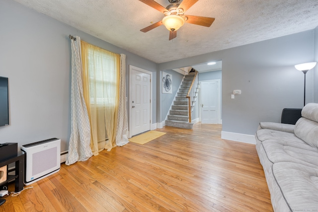 6 Rau Street Ext, Vernon, CT 06066 - living area with stairs, light wood-type flooring, a ceiling fan, and a textured ceiling