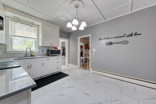 6 Rau Street Ext, Vernon, CT 06066 - kitchen featuring light marble finish floors, backsplash, white cabinets, and a chandelier