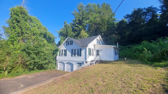 62 Park St, Stafford, CT 06076 - view of front of home featuring an attached garage, concrete driveway, and a front yard