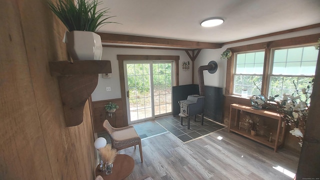 62 Park St, Stafford, CT 06076 - sitting room with a wainscoted wall, wood finished floors, and a wood stove
