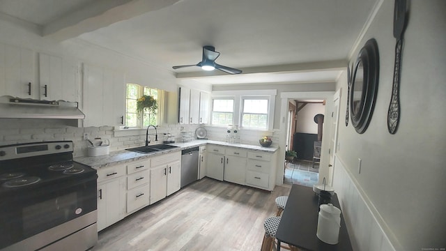 62 Park St, Stafford, CT 06076 - kitchen with appliances with stainless steel finishes, ventilation hood, tasteful backsplash, ceiling fan, and light wood-style floors