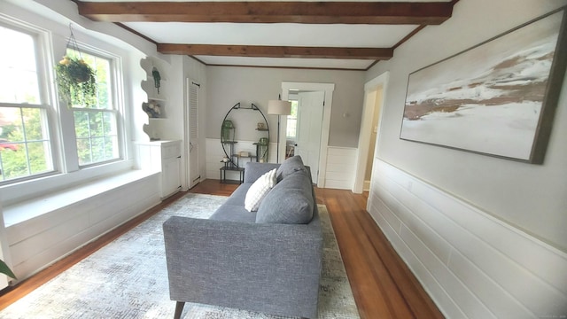 62 Park St, Stafford, CT 06076 - living room featuring wood finished floors, beamed ceiling, and wainscoting