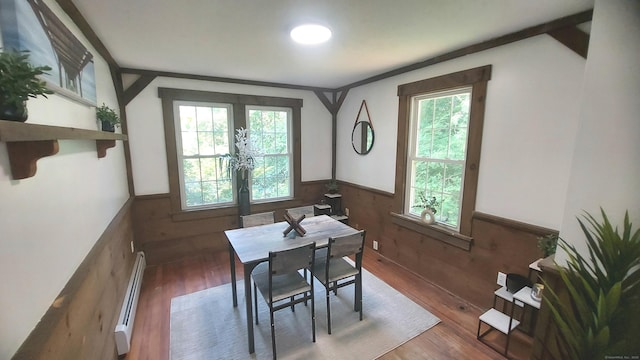 62 Park St, Stafford, CT 06076 - dining area featuring baseboard heating, a wainscoted wall, wood finished floors, and wood walls