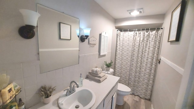 62 Park St, Stafford, CT 06076 - full bath with tile walls, vanity, curtained shower, and wood finished floors