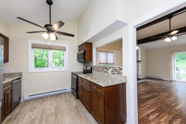 17 Pilgrim Hbr Unit A, Wallingford, CT 06492 - kitchen featuring stainless steel appliances, a baseboard radiator, a ceiling fan, and light wood-style floors