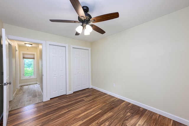 17 Pilgrim Hbr Unit A, Wallingford, CT 06492 - unfurnished bedroom with dark wood-style floors, two closets, attic access, and a ceiling fan
