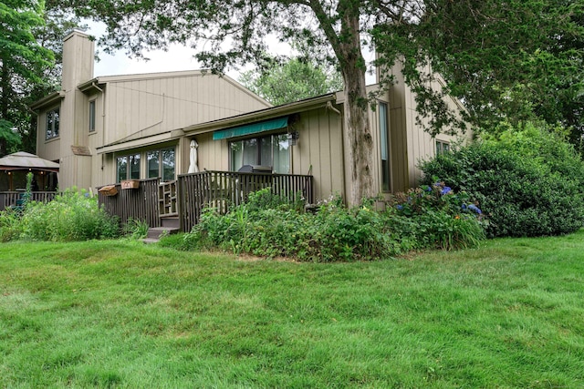 17 Pilgrim Hbr Unit A, Wallingford, CT 06492 - back of property featuring a chimney, a lawn, and a gazebo