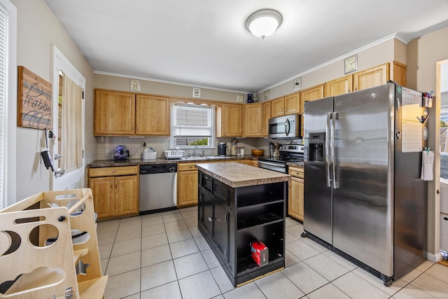 116 Esther Ave, Waterbury, CT 06708 - kitchen featuring appliances with stainless steel finishes, crown molding, light tile patterned flooring, backsplash, and a kitchen island