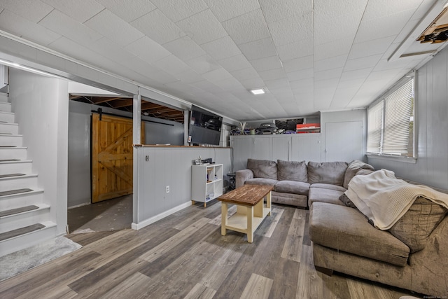 116 Esther Ave, Waterbury, CT 06708 - living area featuring a barn door, stairway, and wood finished floors