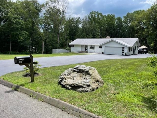 48 Mulberry Rd, Woodbridge, CT 06525 - single story home featuring a front yard, driveway, and a wooded view