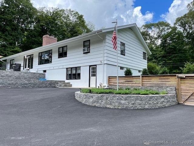 48 Mulberry Rd, Woodbridge, CT 06525 - view of home's exterior featuring a chimney, cooling unit, and asphalt driveway