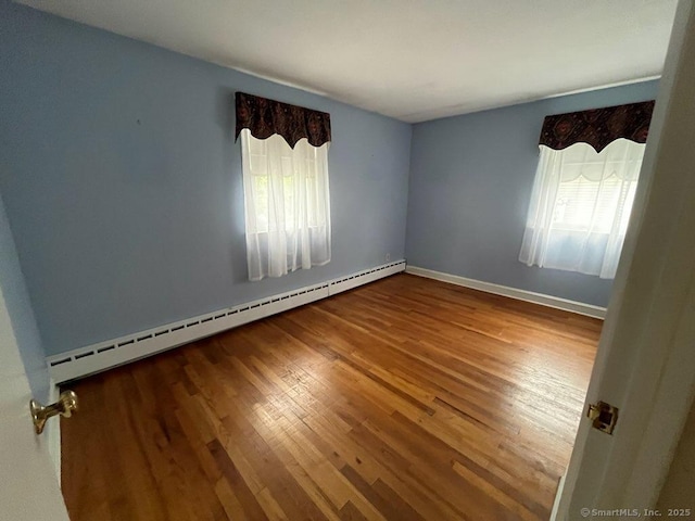 117 Lyons Rd, Bristol, CT 06010 - unfurnished room with baseboard heating and wood finished floors