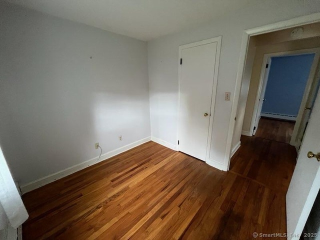 117 Lyons Rd, Bristol, CT 06010 - spare room with wood finished floors and a baseboard radiator