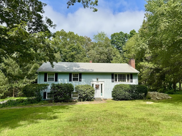 105 Chesterfield Rd, East Lyme, CT 06333 - split foyer home with a front yard and a chimney