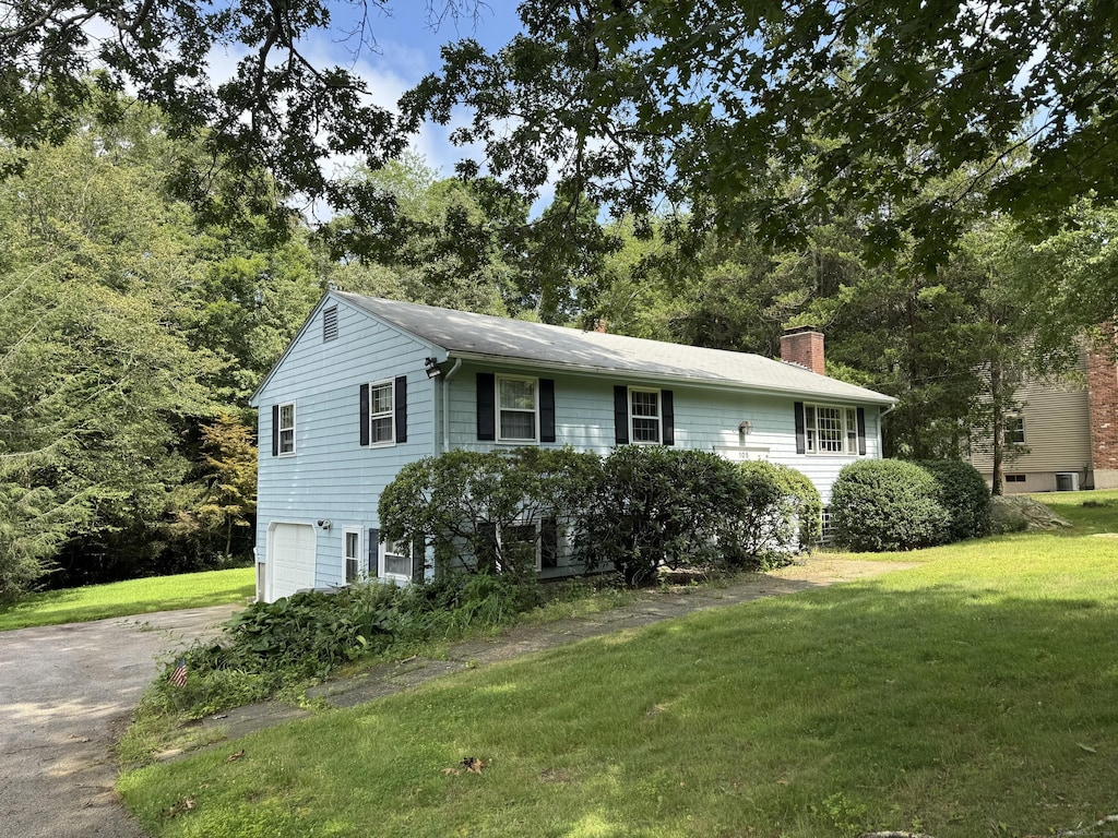 105 Chesterfield Rd, East Lyme, CT 06333 - view of front of home featuring a garage, a chimney, a front yard, and driveway