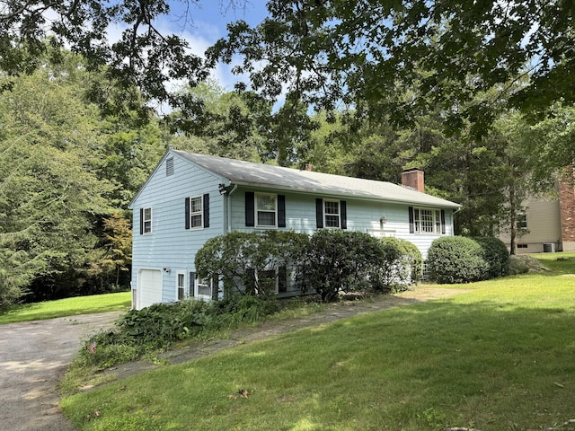 105 Chesterfield Rd, East Lyme, CT 06333 - view of front of home featuring a garage, a chimney, a front yard, and driveway