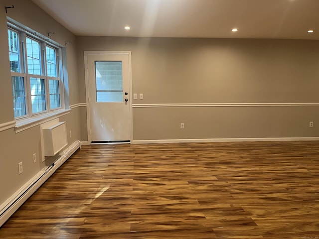 2955 Madison Ave Apt 40, Bridgeport, CT 06606 - empty room featuring a baseboard heating unit, dark wood-style floors, and recessed lighting