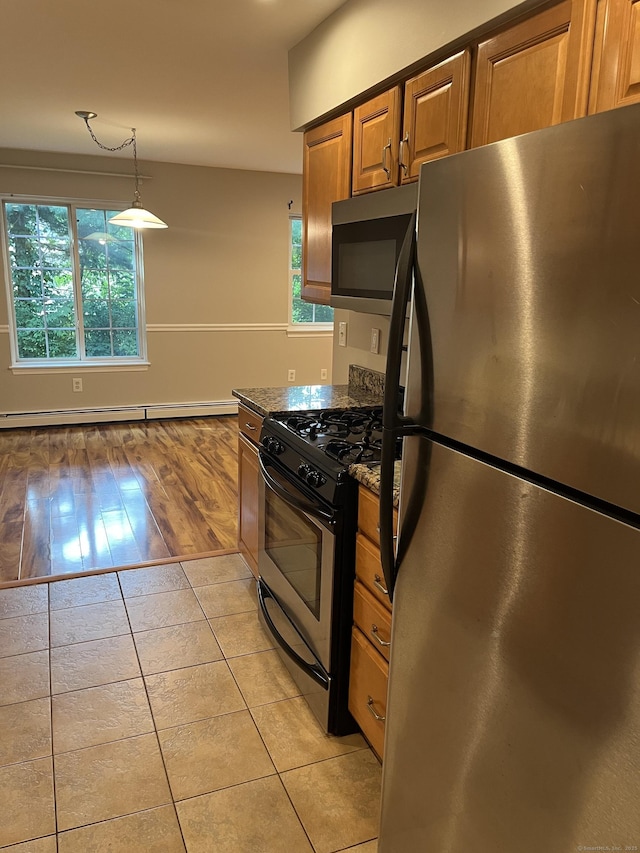 2955 Madison Ave Apt 40, Bridgeport, CT 06606 - kitchen featuring appliances with stainless steel finishes, a baseboard heating unit, plenty of natural light, and light tile patterned floors