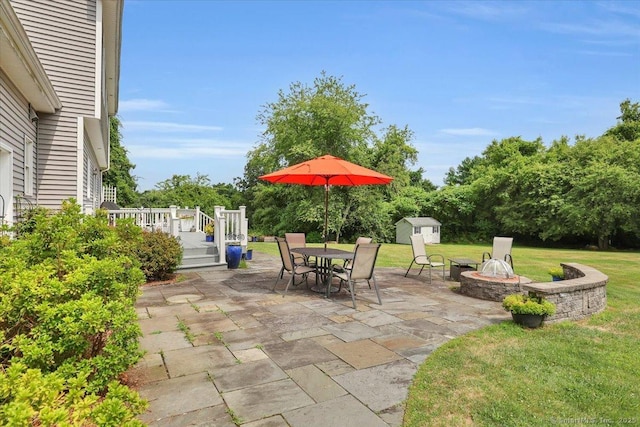2 Kimberly Way, Marlborough, CT 06447 - view of patio with a storage unit, a fire pit, outdoor dining area, and a wooden deck