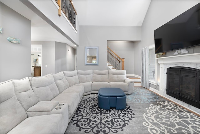 14 Finn Ln, Plainfield, CT 06374 - living area featuring a premium fireplace, a high ceiling, stairs, and wood finished floors
