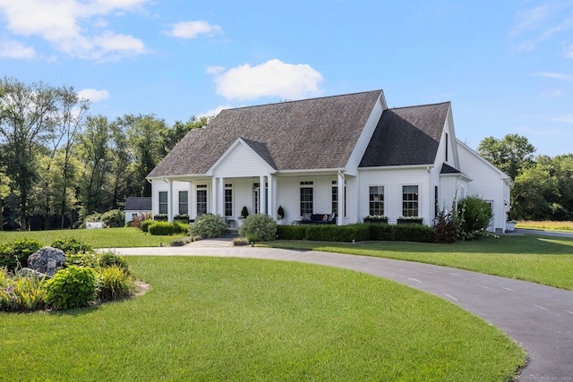 14 Finn Ln, Plainfield, CT 06374 - new england style home featuring a porch, a front yard, and roof with shingles