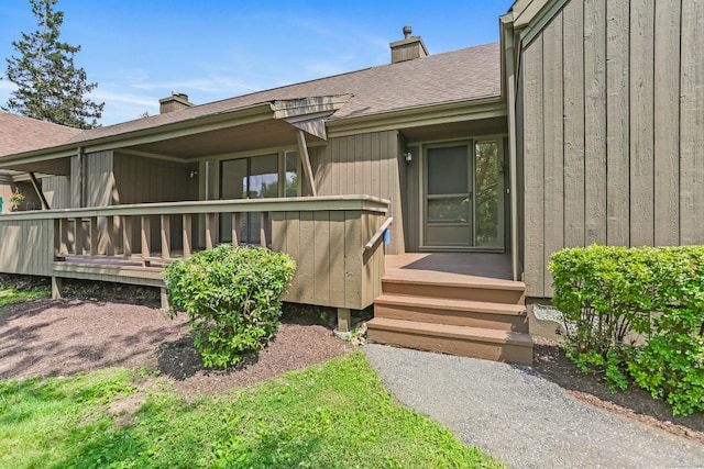 194 Bayfield Ln Unit A, Stratford, CT 06614 - property entrance featuring a chimney, roof with shingles, and a wooden deck