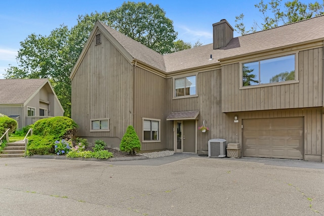 194 Bayfield Ln Unit A, Stratford, CT 06614 - view of front of property with a chimney, roof with shingles, and an attached garage