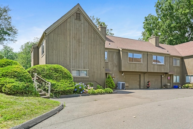 194 Bayfield Ln Unit A, Stratford, CT 06614 - view of building exterior with an attached garage and asphalt driveway