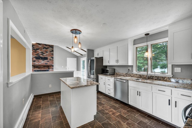 7 Lorraine Rd, Manchester, CT 06040 - kitchen featuring appliances with stainless steel finishes, healthy amount of natural light, a kitchen island, baseboard heating, and a textured ceiling