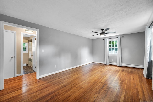 7 Lorraine Rd, Manchester, CT 06040 - empty room with hardwood / wood-style flooring, a ceiling fan, a baseboard radiator, and a textured ceiling