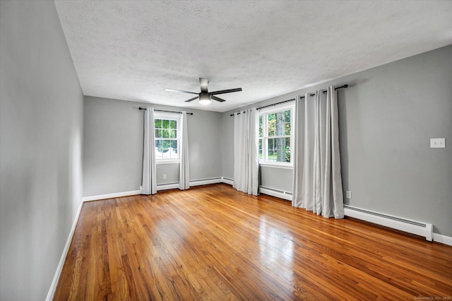 7 Lorraine Rd, Manchester, CT 06040 - empty room with a baseboard radiator, wood finished floors, a ceiling fan, and a textured ceiling