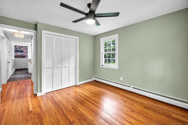 7 Lorraine Rd, Manchester, CT 06040 - unfurnished bedroom with a baseboard radiator, a closet, wood finished floors, and a ceiling fan