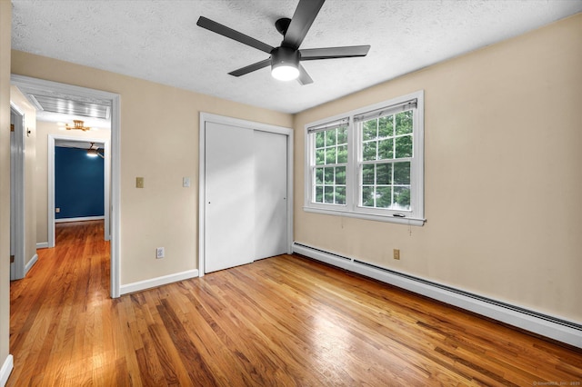 7 Lorraine Rd, Manchester, CT 06040 - unfurnished bedroom featuring a baseboard heating unit, light wood-style flooring, a closet, a textured ceiling, and ceiling fan
