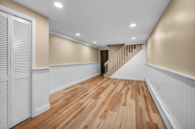 7 Lorraine Rd, Manchester, CT 06040 - below grade area featuring a wainscoted wall, stairway, wood finished floors, a baseboard radiator, and recessed lighting