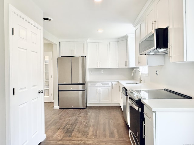 10 Meadowpark Ave W, Stamford, CT 06905 - kitchen with appliances with stainless steel finishes, wood finished floors, white cabinets, recessed lighting, and light countertops