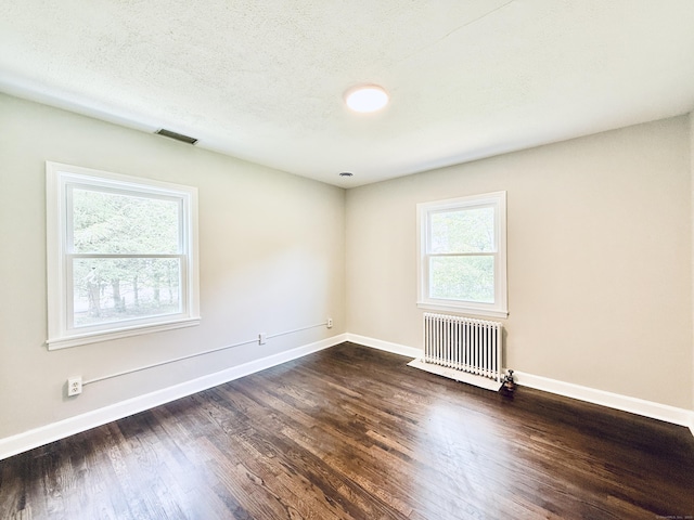 10 Meadowpark Ave W, Stamford, CT 06905 - empty room featuring radiator heating unit and dark wood-type flooring