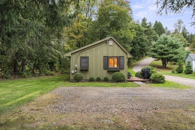 189 Chaplin Rd, Eastford, CT 06242 - view of front facade featuring board and batten siding, a front yard, a wooden deck, and driveway