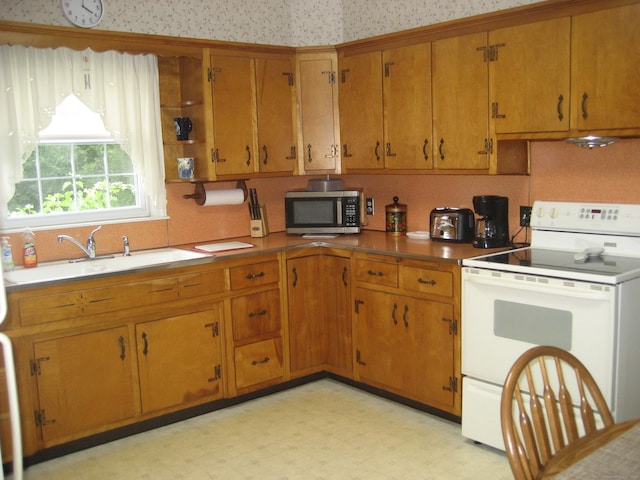46 Wayne St, Norwich, CT 06360 - kitchen featuring electric stove, stainless steel microwave, light flooring, and brown cabinetry