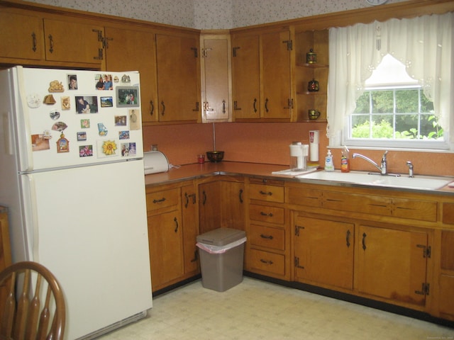 46 Wayne St, Norwich, CT 06360 - kitchen featuring freestanding refrigerator, brown cabinetry, light floors, and open shelves