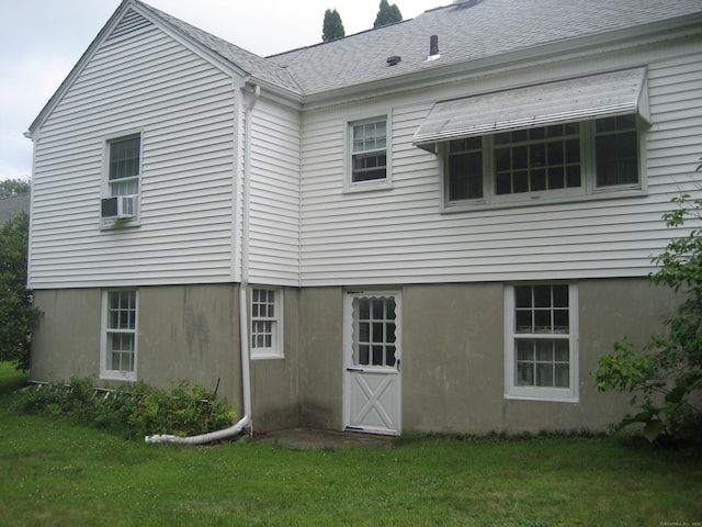 46 Wayne St, Norwich, CT 06360 - back of property featuring a lawn and cooling unit