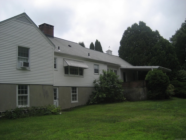 46 Wayne St, Norwich, CT 06360 - rear view of house with a lawn and a chimney