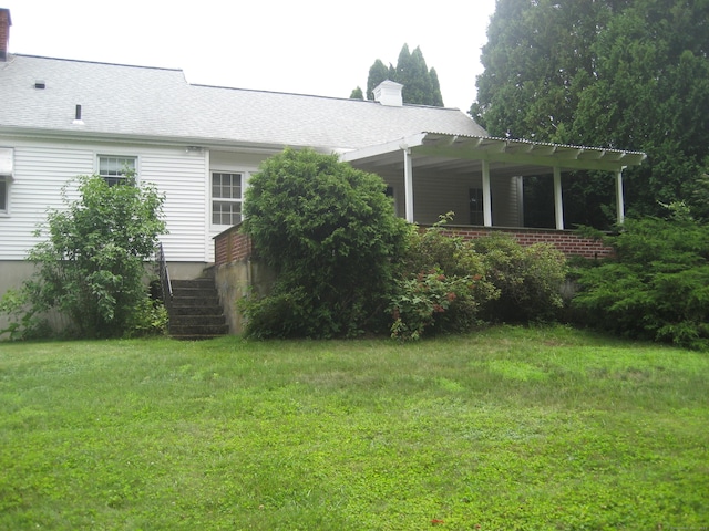 46 Wayne St, Norwich, CT 06360 - view of property exterior with a chimney and a lawn