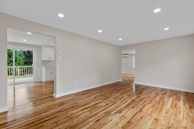 219 Browning Rd, Norwich, CT 06360 - spare room featuring light wood-type flooring, a wall mounted AC, and recessed lighting