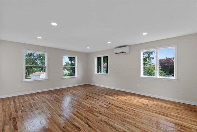 219 Browning Rd, Norwich, CT 06360 - unfurnished room featuring a wall unit AC, healthy amount of natural light, wood finished floors, and recessed lighting