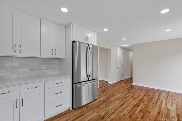219 Browning Rd, Norwich, CT 06360 - kitchen featuring freestanding refrigerator, white cabinets, decorative backsplash, light wood-style flooring, and recessed lighting