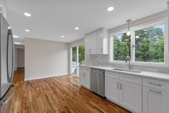 219 Browning Rd, Norwich, CT 06360 - kitchen with appliances with stainless steel finishes, light countertops, backsplash, white cabinets, and recessed lighting