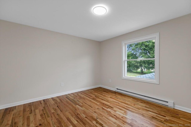 219 Browning Rd, Norwich, CT 06360 - empty room featuring a baseboard heating unit and wood finished floors