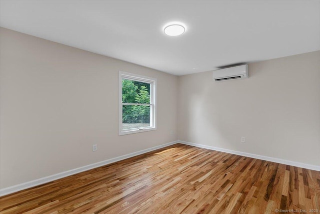 219 Browning Rd, Norwich, CT 06360 - spare room with a wall mounted air conditioner and light wood-style flooring